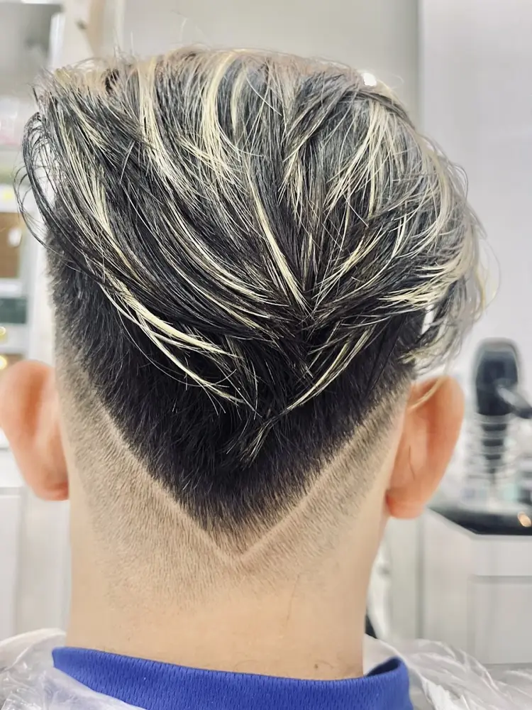 Client with silver highlights and a V-shaped nape, done at Groom Studio